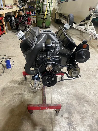 Black marine engine on a stand ready for installation