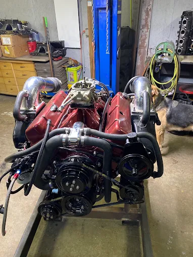 Red marine engine rebuild with chrome exhaust risers